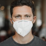 Close up portrait of men in respirator mask at the airport coronavirus covid 19 and air pollution t20 nlzbao